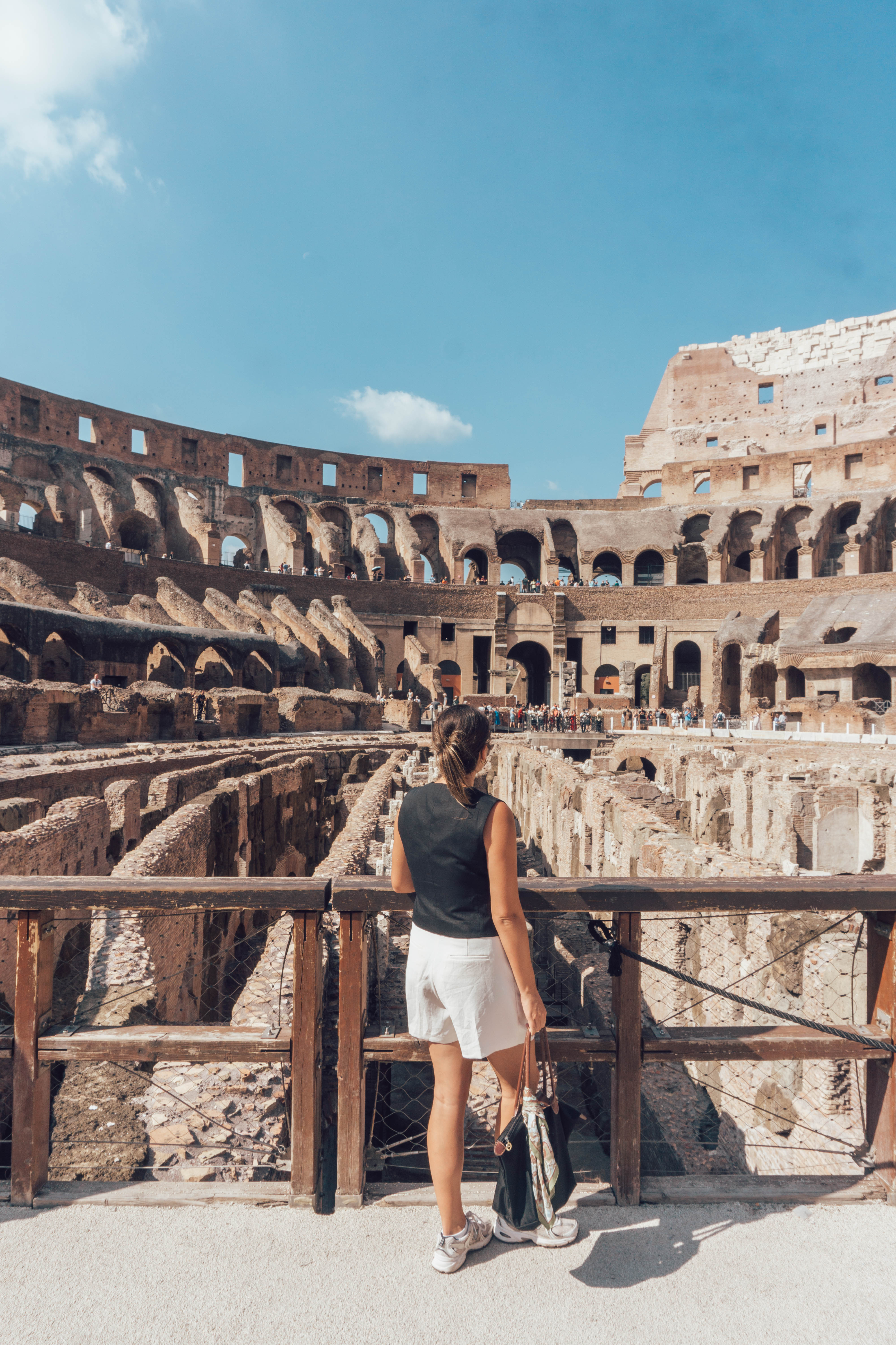 A girl looks out at the ancient remains of the Colosseum in Rome - a must see during your 48 hours in this ancient city