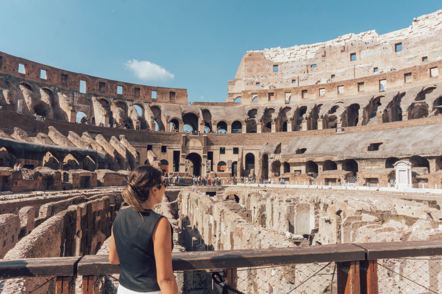 A girl with brown hair in the Colosseum admiring the view. A must-do during your 2 days in Rome itinerary