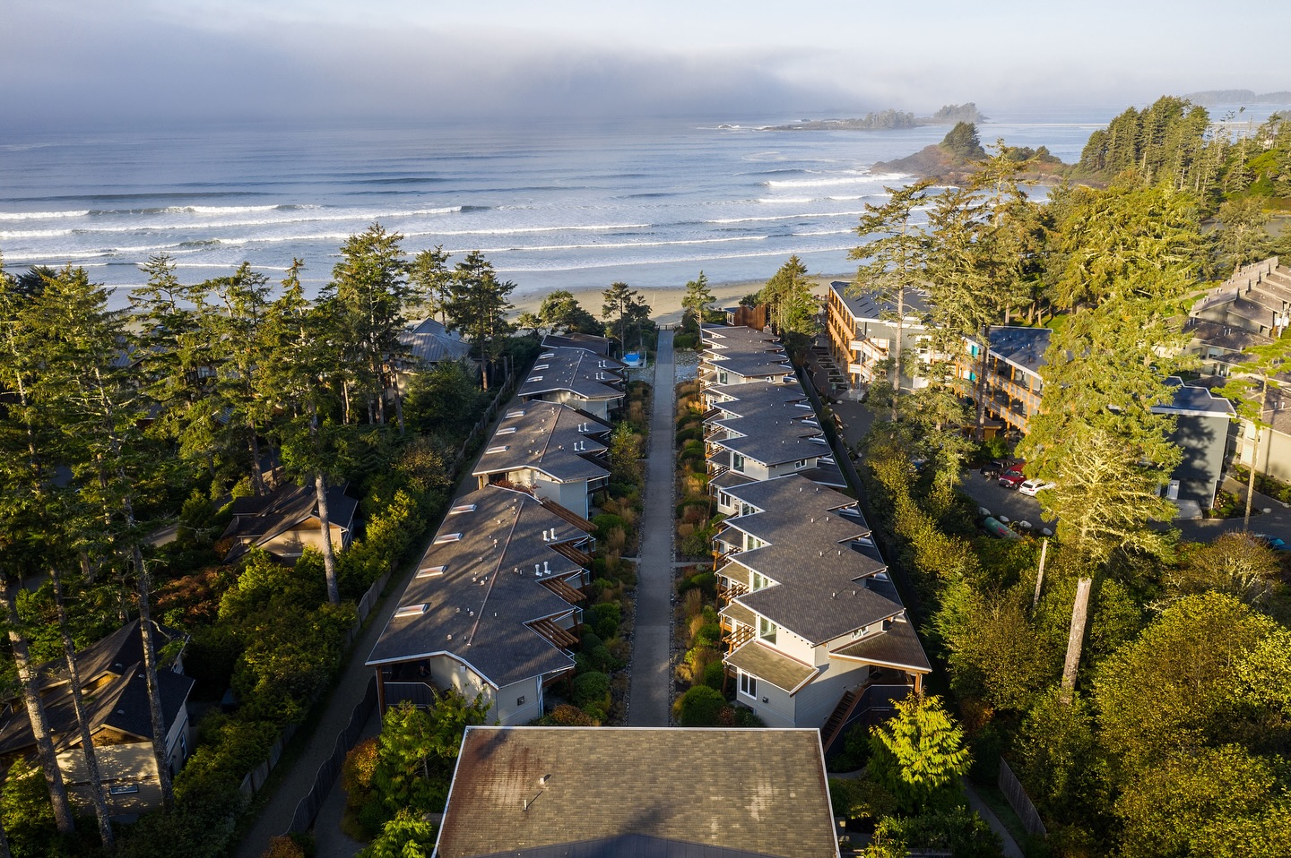 An ariel shot over the Cox Bay Beach Resort with the ocean waves in the background