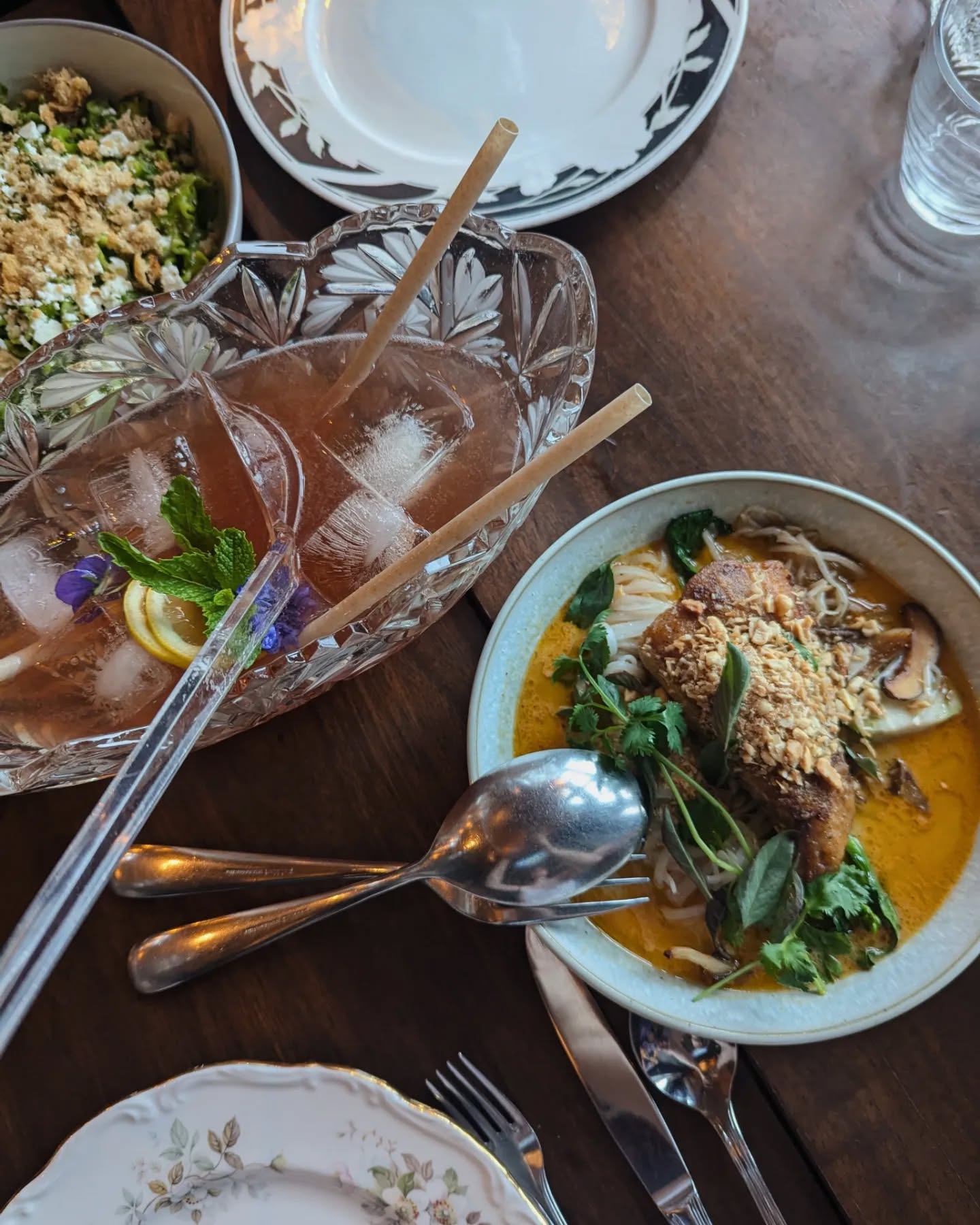 Looking down at a two platters of food and a bowl of punch at Wolf in the Fog, one of the best restaurants in Tofino