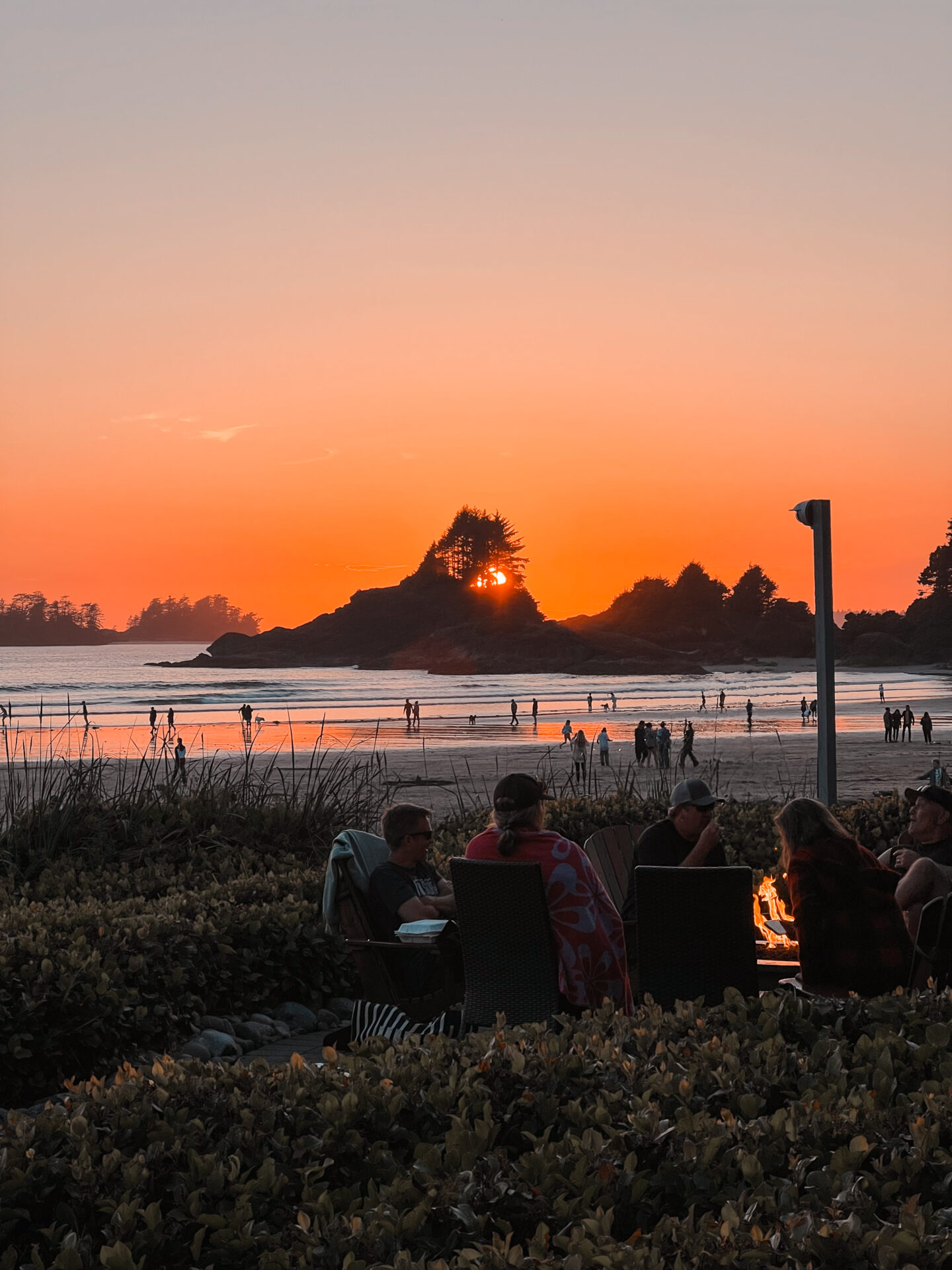 People watching the sunset at Cox Bay Beach, from the beachside fire pits at Long Beach Lodge. 